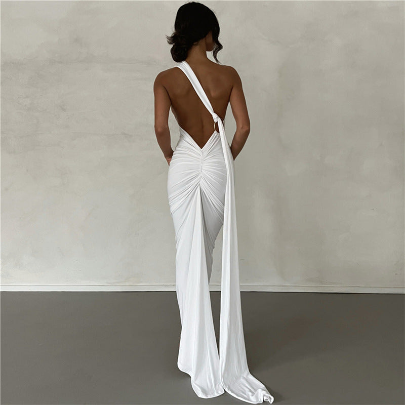 A backless, off-the-neck, body-hugging evening dress