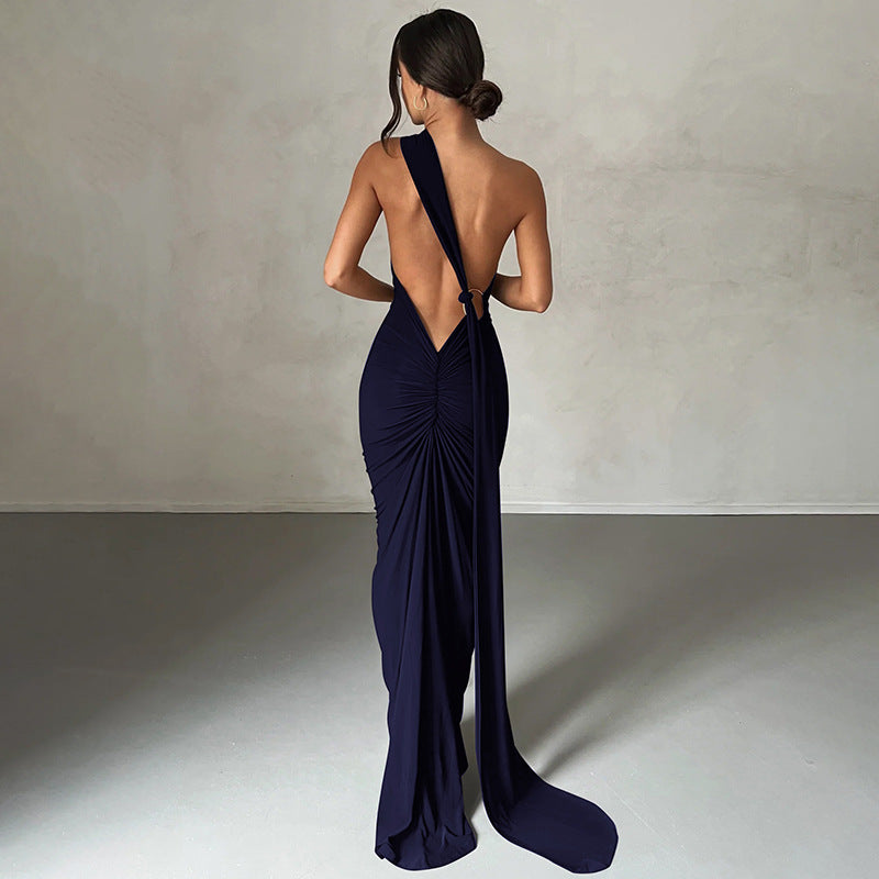 A backless, off-the-neck, body-hugging evening dress