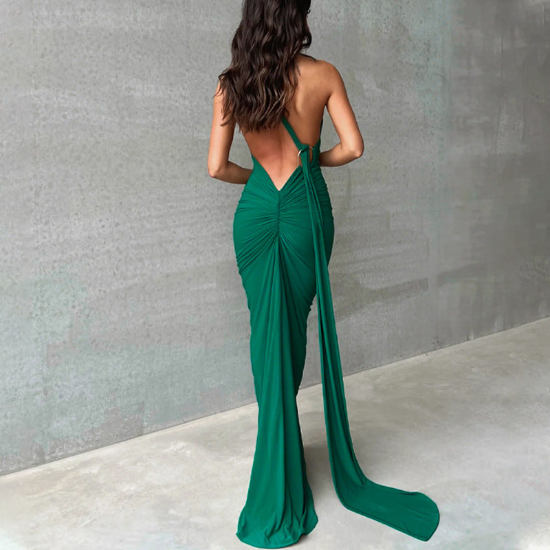A backless, off-the-neck, body-hugging evening dress