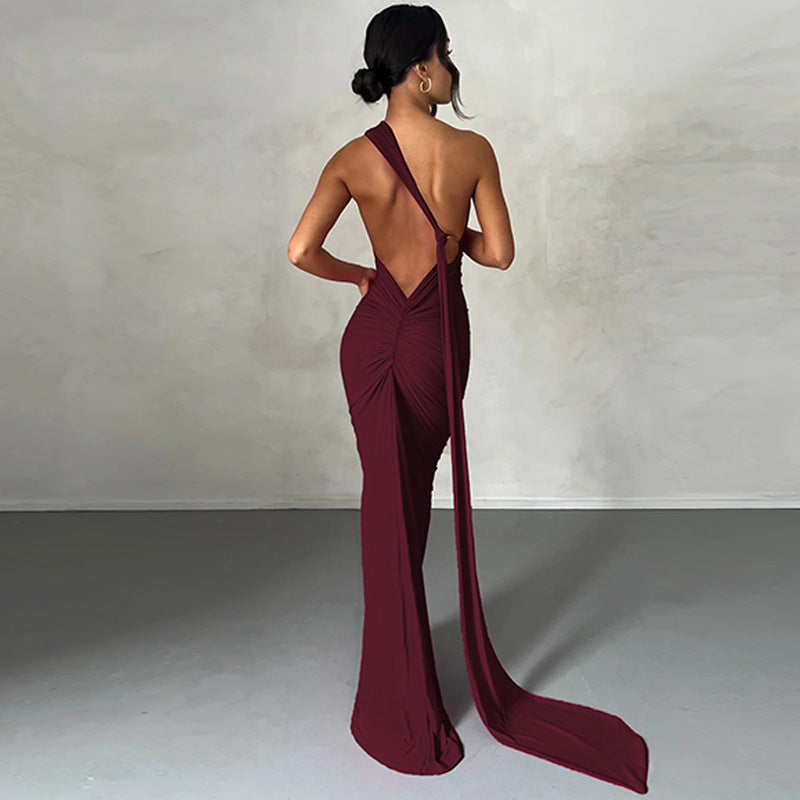 A backless, off-the-neck, body-hugging evening dress