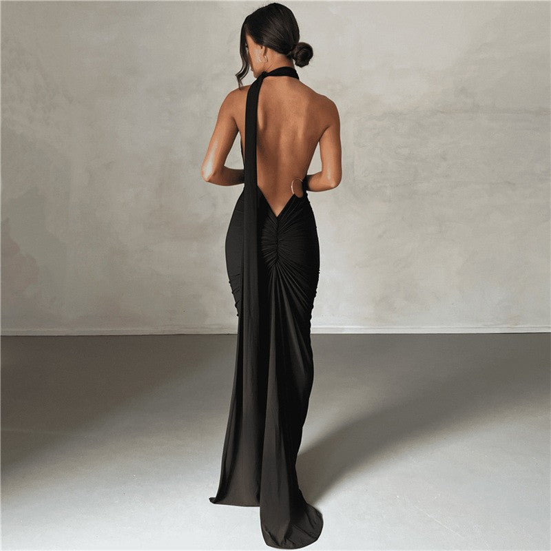 A backless, off-the-neck, body-hugging evening dress