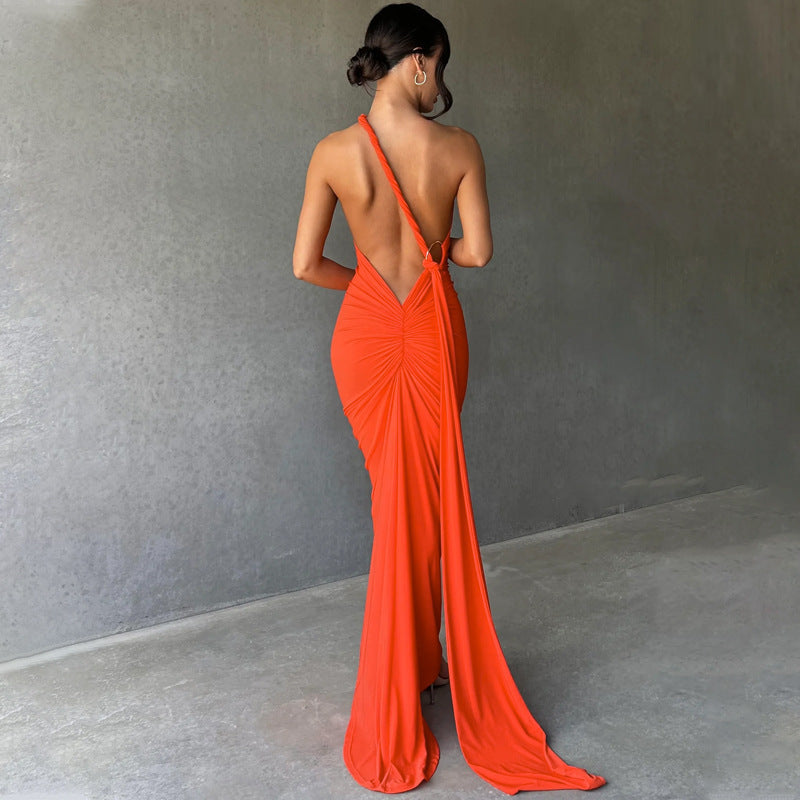 A backless, off-the-neck, body-hugging evening dress